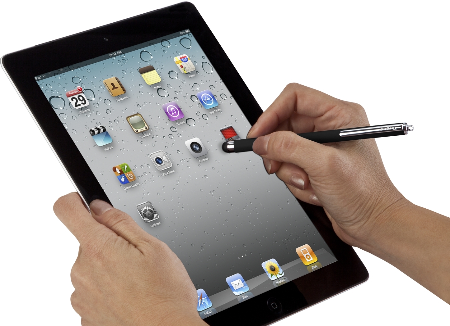  A person's hands holding a tablet with a stylus pen poised above the screen with various apps displayed on the device.