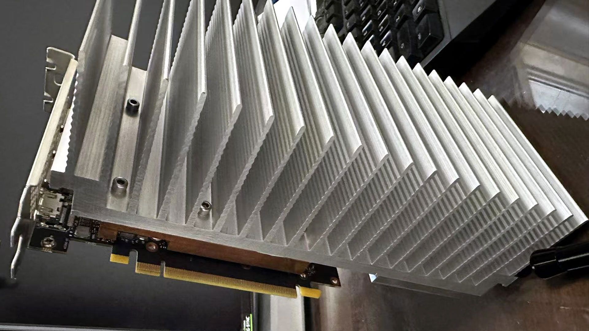 PC modder bolts 5.5-pound aluminum heatsink to RTX 4060 — convection-only cooling seems to work fine in a testbench-style installation