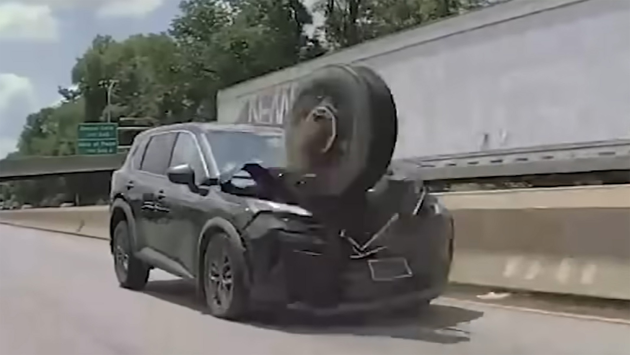 Runaway Tire Jumps Highway Median And Wrecks A Nissan SUV On Camera | Carscoops