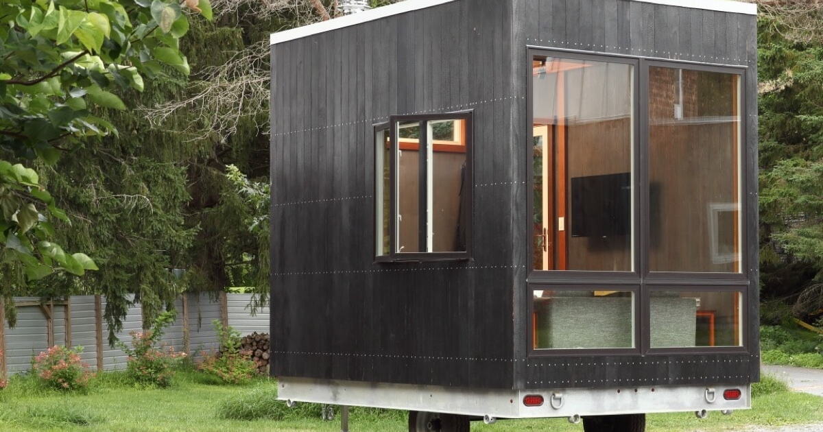 Space-saving cuboid tiny house stows a bed beneath its floor