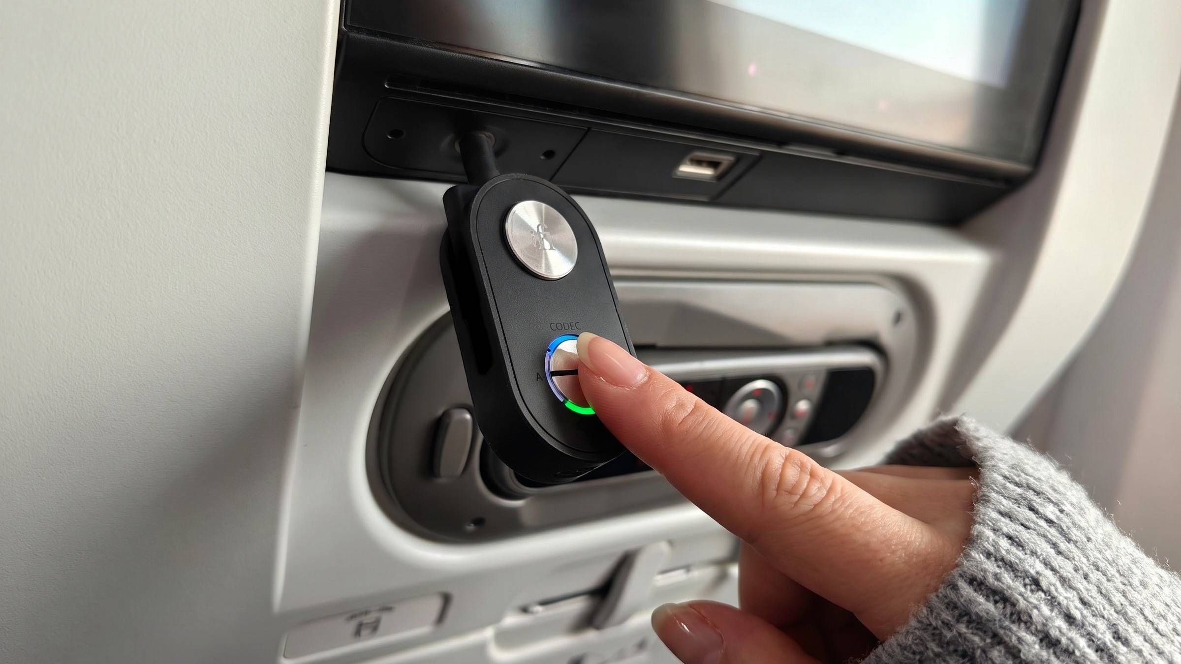 This tiny iFi gadget lets you use your wireless headphones for in-flight movies (to bypass those standard-issue crackly wired buds)